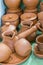 Lots of traditional ukrainian handmade clay pottery production. brown pottery. Clay plates and cups. vertical photo