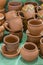 Lots of traditional ukrainian handmade clay pottery production. brown pottery. Clay plates and cups. vertical photo