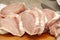 Lots of uncooked fresh juicy raw fat pork chop meat pieces, freshly cut up, food, object closeup, nobody. Unprocessed pig meat