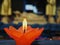 A lotus flower candle with light for pray to Buddha. First light the candle, second pray, and third put candle flower into water.