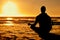 Lotus, yoga and silhouette of man at beach outdoors for health and wellness. Sunset, zen meditation and shadow or