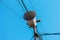 Loud Speaker or vintage white horn speaker on the pole. For public relations in the community. With wires, cables and blue skies