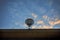 Loudspeaker on building roof against beautiful morning colorful sky