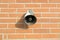 Loudspeaker on red brick wall