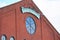 Louisville Slugger Field sign above round window set in brick building