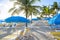 Lounge Chairs and beach umbrellas at a beautiful beach resort.