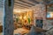 Lounge room rustic support and ceiling beams  brick wall and golden hue lighting reflected in mirror