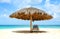 Lounger under cabana, parasol. Blue sea water and dramatic clouds. Oranjestad, Aruba. Famous Eagle Beach