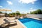 Loungers placed on the left and in the front of a pool with clean looking water on a sunny day.