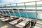 Loungers reclined on sun deck of cruise ship