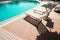 Lounging pool. Summer resort chair, relax lounge at hotel pool. Beach lounger chaise. Vacation sunbed. Luxury travel