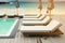 Lounging Sunbeds on Swimming Pool Wooden Deck with Seascape Background