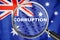 Loupe focused on the word corruption on Australia flag background. Corruption, financial concept in Australia