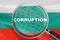 Loupe focused on the word corruption on Bulgaria flag background. Corruption, financial concept in Bulgaria