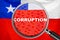 Loupe focused on the word corruption on Chile flag background. Corruption, financial concept in Chile