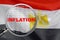Loupe focused on the word inflation on Egypt flag background. Inflation, tax, financial concept in Egypt