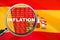 Loupe focused on the word inflation on Spain flag background. Inflation, tax, financial concept in Spain
