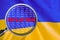 Loupe focused on the word inflation on Ukraine flag background. Inflation, tax, financial concept in Ukraine