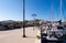 LOUTRA, Greece. Pier in Loutra Marina Kythnos with sailing boats moored, lanterns and traditional greek whitewashed houses.