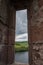 Louver in the wall of the ruins of Urquhart Castle with Loch Ness behind