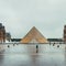 Louvre museum and its pyramide in the rain, Paris