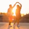 Love is in the air. Romantic couple dancing at sunset