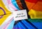 LOVE IS ALL WE NEED text on valentine card inscription positive quote phrase Greeting card on Rainbow LGBTQIA flag made