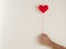 Love background, hand holding red heart knitting shape