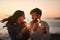 Love, beach and couple with sparklers for celebration, party and quality time on romantic date. Nature, sunset and happy