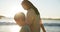 Love, beach or sunset with a mother and son on the sand by the ocean at sunset together. Family, smile or vacation with