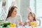 We love beautiful traditions.Mom and daughter paint eggs, dad holds a home decorative rabbit