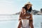 Love brings so much contentment in life. a young man piggybacking his girlfriend at the beach.