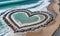 Love Carved in Stone: Heart-Shaped Rocks Gracing a Seaside Beach