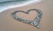 Love Carved in Stone: Heart-Shaped Rocks Gracing a Seaside Beach