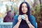 Love for coffee. Portrait of cute girl drinking enjoying her tea on the balcony over outside terrace with green bush background, w