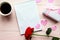 Love composition - coffee cup, gift box and red rose on pink background, top view.