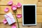 Love composition - rose, gift box and mockup black tablet on wooden background.