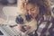 Love concept for beautiful curly blonde middle age caucasian woman and her best friend old dog pug - hug and friendship human