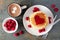 Love concept breakfast pancakes, hot chocolate and raspberries over slate