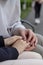 love concept - close up of engaged couple holding hands with ring