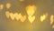 Love concept. Valentine's Day. golden bokeh hearts on blurred background.Glowing bokeh hearts. Love symbol.Festive