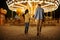 Love couple at the carousel, night amusement park