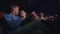 Love couple kissing in cinema. Romantic couple embracing in movie theatre