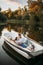 Love couple lying in a boat on lake at sunset