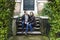 Love couple sitting on traditional Dutch porch looking happy