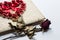 Love diary and Roses wilt on white canvas background