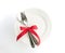 love dinner setting fork and spoon tie with red ribbon on plate