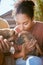 Love, dog and animal shelter with a black woman kissing a puppy at a rescue pound for adoption or care. Pet, homeless