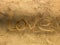 Love drown on sand beach and shadow,Romantic background