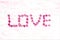 LOVE floral background made from pink acacia petals